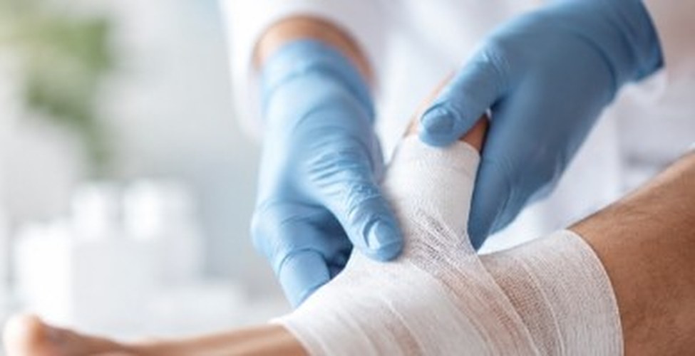 Nurse applying a dressing to a patient's foot